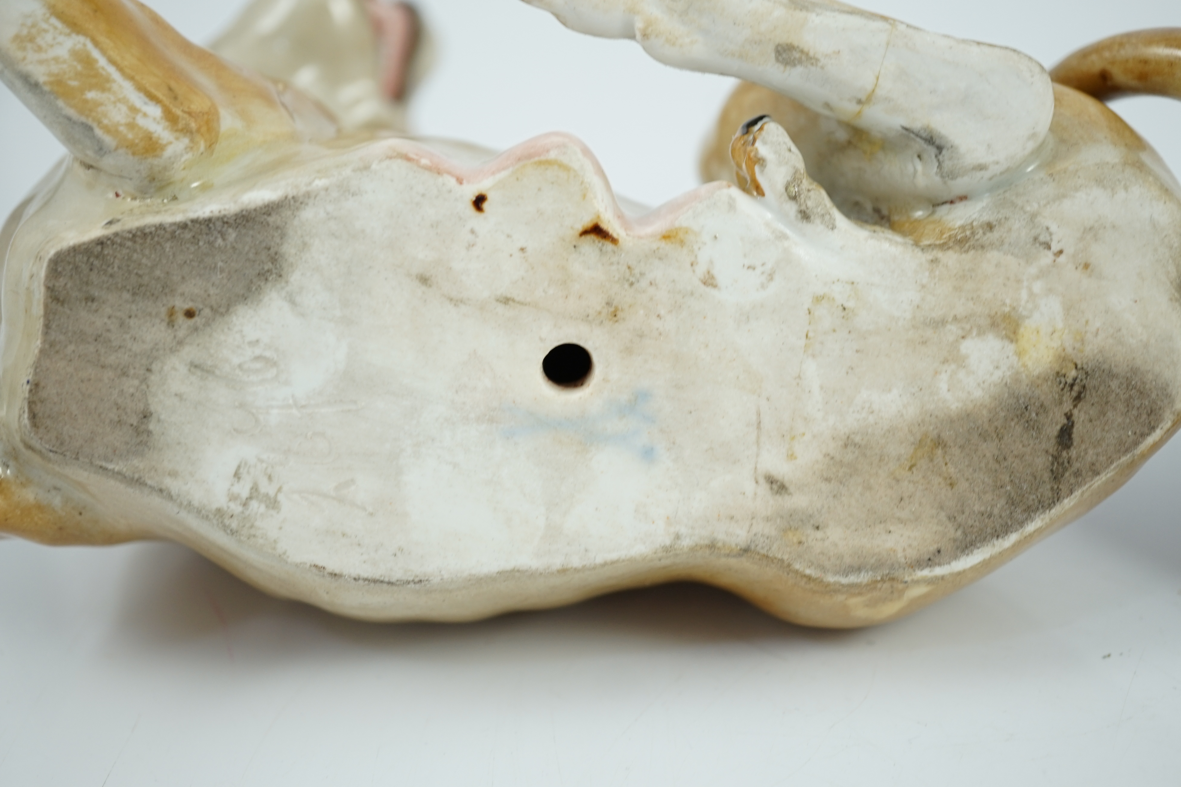 A pair of Meissen figures of a recumbent lion and lioness, 19th century, restoration